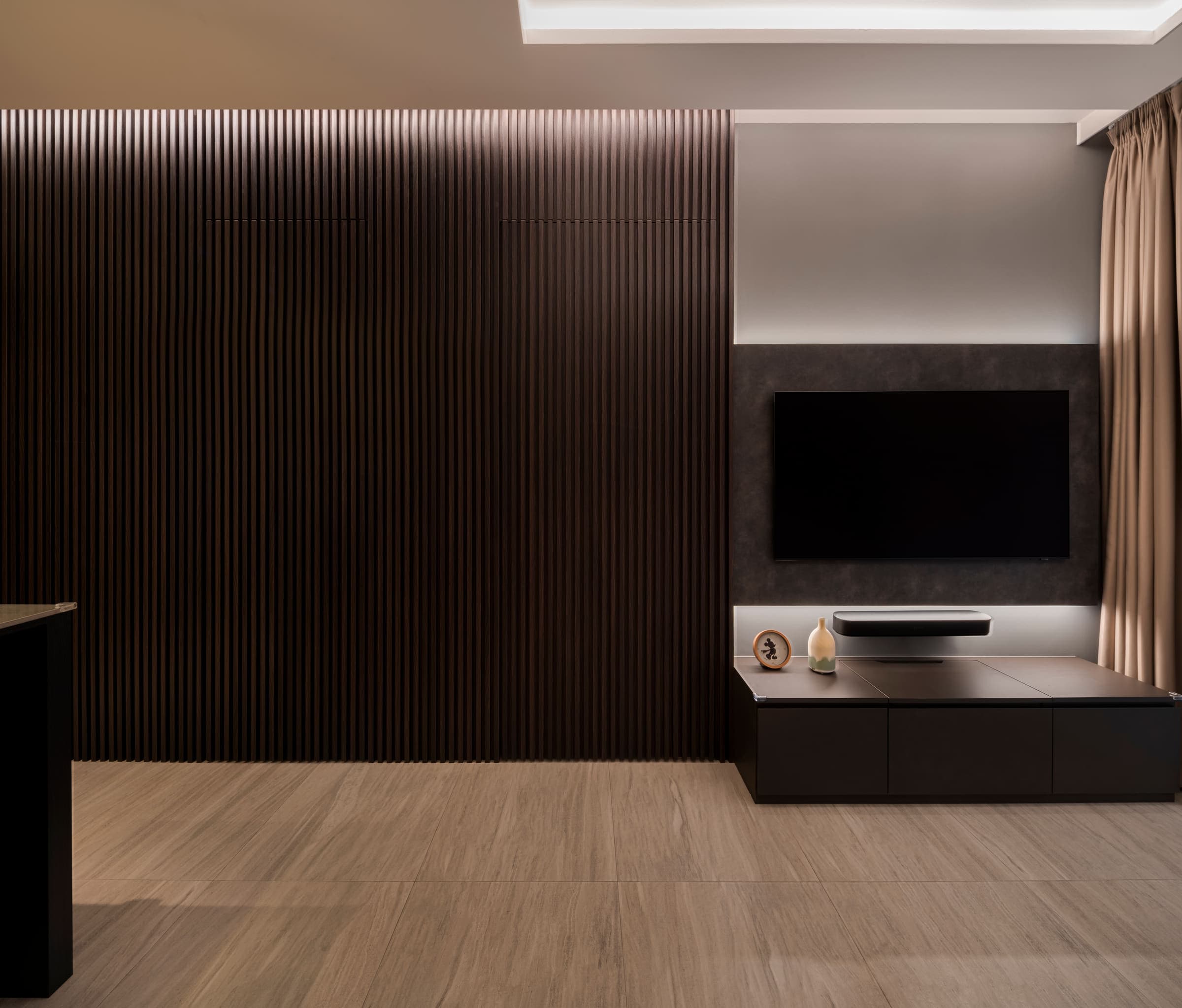 The same living room at a neutral white setting, the timber reading browner and the wall behind the screen cooler.